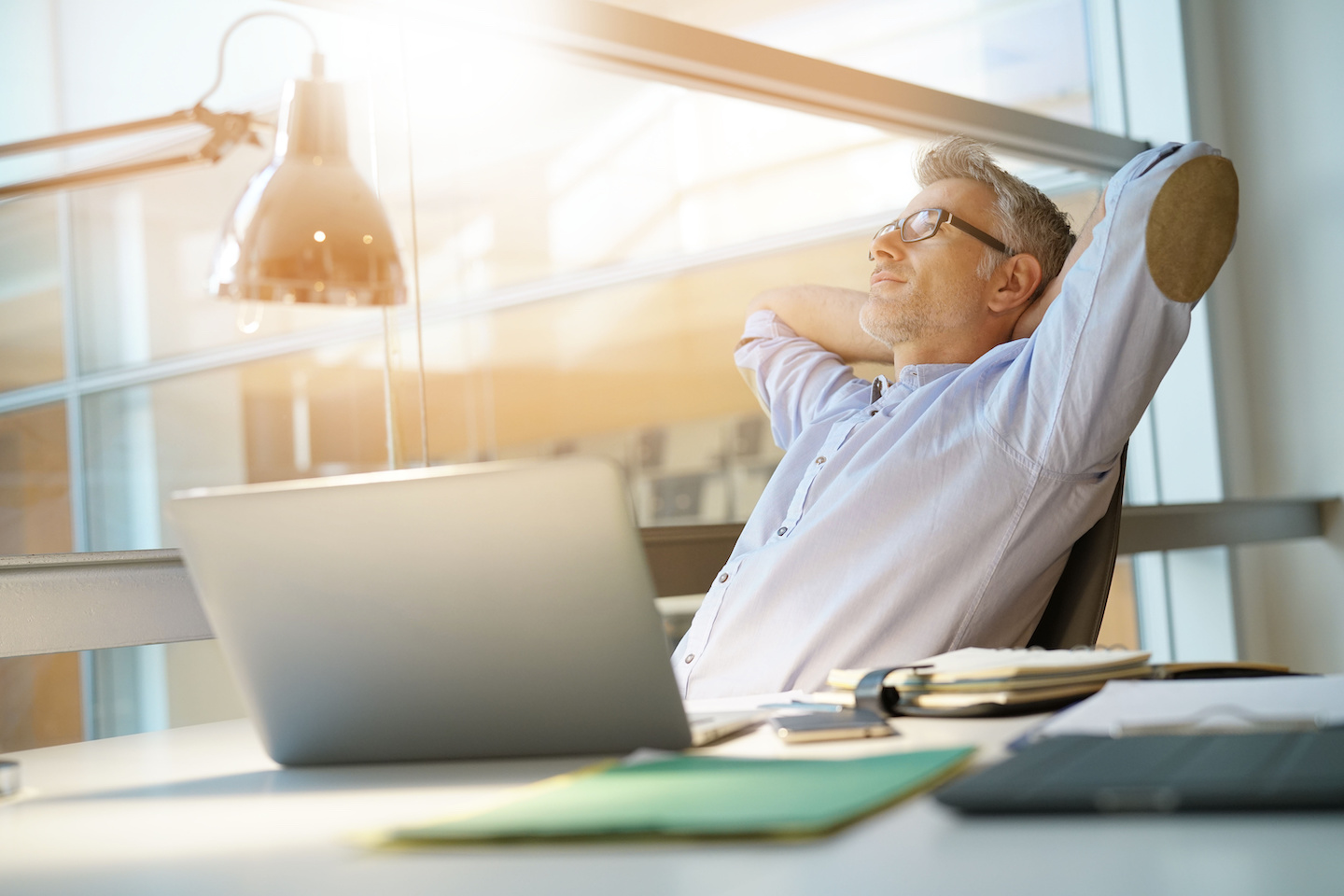 Businessman in office relaxing in chair Accounting Software